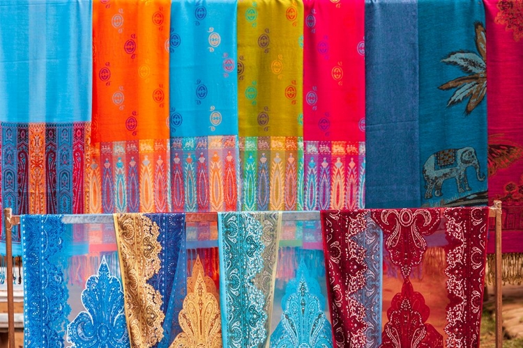 Picture of LAOS- LUANG PRABANG. COLORFUL TEXTILES- POSSIBLY SCARVES- FOR SALE.