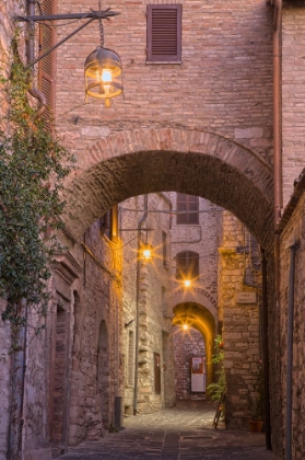 Picture of ITALY- UMBRIA- ASSISI. ALLEYWAY WITH ARCHES AND LANTERNS IN THE EVENING.