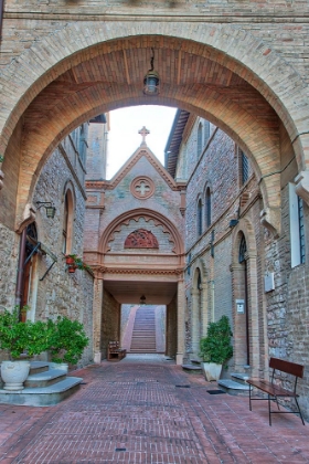 Picture of ITALY- UMBRIA- ASSISI. ARCHWAY AND PATH LEADING TO THE MONASTERO DELLA SANTA CROCE CATHOLIC CHURCH.