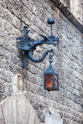 Picture of ITALY- UMBRIA- ASSISI. OLD STONE WALL WITH DRAGON LANTERN.
