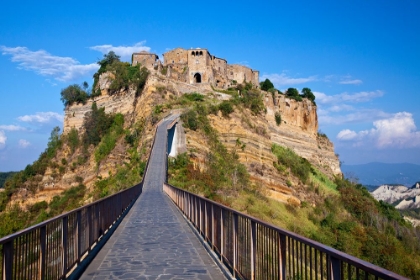 Picture of ITALY- TUSCANY. EVENING VIEW OF CIVITA DI BAGNOREGIO AND THE LONG BRIDGE LEADING TO TOWN.