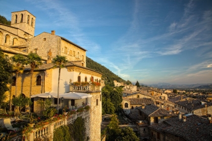 Picture of ITALY- UMBRIA. EVENING LIGHT ON FLOWER COVERED BUILDINGS OVERLOOKING THE MEDIEVAL TOWN OF GUBBIO.