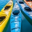 Picture of FOUR COLORFUL KAYAKS POSITIONED IN AN ARRAY.