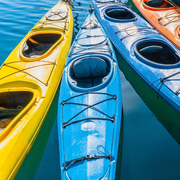 Picture of FOUR COLORFUL KAYAKS POSITIONED IN AN ARRAY.