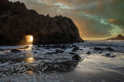 Picture of SUNSET SHINES THROUGH A TUNNEL IN THIS SEA ROCK AT BIG SUR.