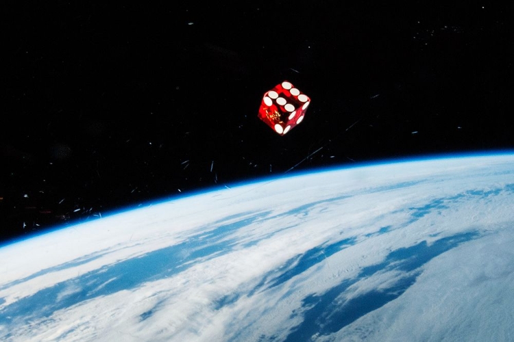 Picture of A DICE FLOATING IN SPACE ABOARD THE ISS