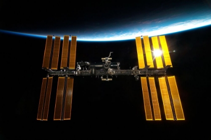 Picture of THE INTERNATIONAL SPACE STATION BACKDROPPED BY EARTH’S HORIZON