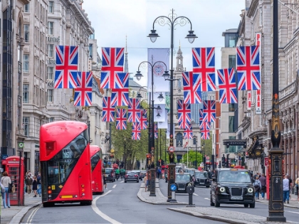 Picture of DOUBLE DECKER BUSES AND TAXIS ON STREET OF LONDON WITH BRITISH FLAGS
