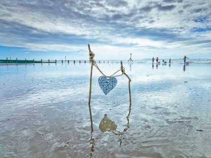Picture of HEART TIED UP ON WOODEN STICKS AT THE BEACH