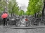 Picture of WOMAN WITH UMBRELLA BY THE CANAL, AMSTERDAM