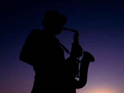 Picture of A MUSICIAN PLAYING THE SAXOPHONE AT SUNSET