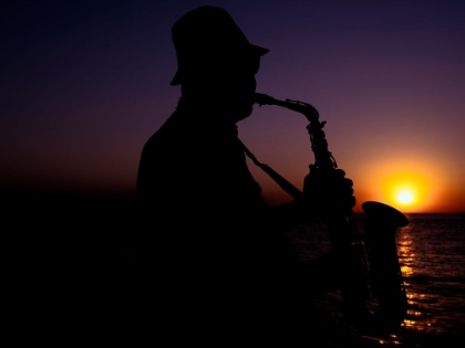 Picture of A MUSICIAN PLAYING THE SAXOPHONE AT SUNSET