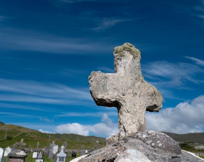 Picture of WORN STONE CROSS ADORNS A GRAVE IN KILDAVNET-ACHILL ISLAND-COUNTY MAYO-IRELAND.