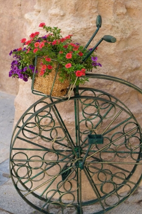 Picture of CORDOBA-SPAIN. BICYCLE PLANTER IN FRONT OF OLD STONE BUILDING