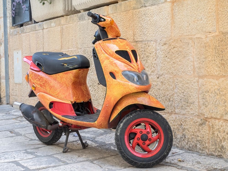 Picture of CROATIA-HVAR. BRIGHT ORANGE VESPA BIKE IN THE TOWN OF HVAR. (EDITORIAL USE ONLY)