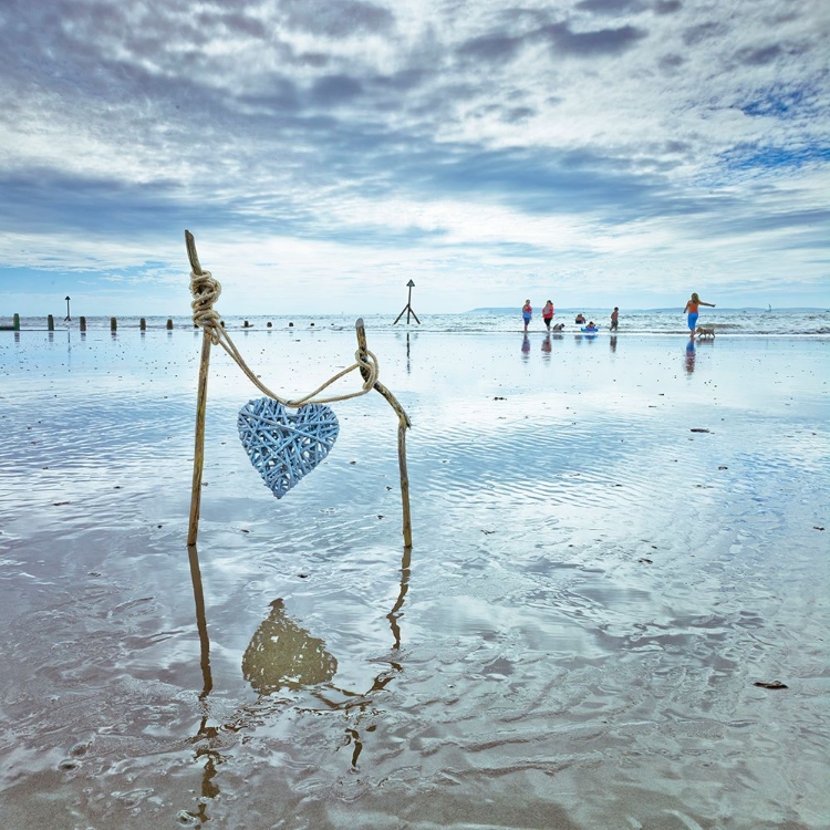 Picture of HEART TIED UP ON WOODEN STICKS AT THE BEACH