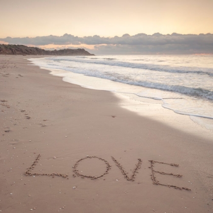 Picture of LOVE" WORD WRITTEN ON SAND AT THE BEACH"