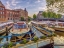 Picture of BOATS MOORED IN THE CANAL THROUGH AMSTERDAM CITY